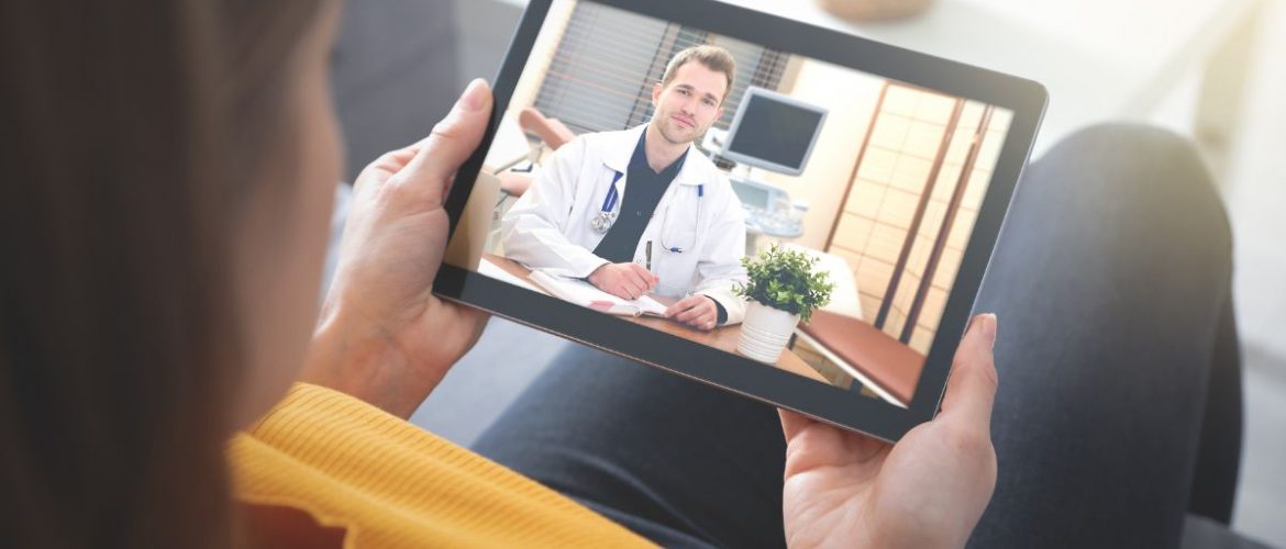 Woman consulting with doctor on tablet
