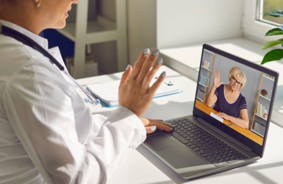 Doctor waving to patient on screen