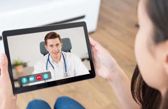 Patient consulting with doctor on tablet