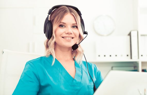 Attentive specialist of medical call center in headphones in office