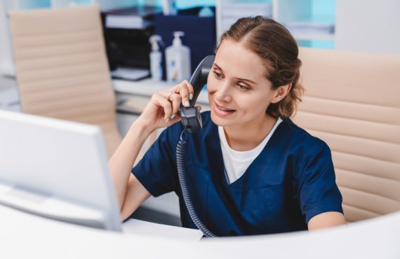 female medical help desk receptionist