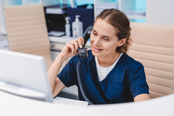 female medical help desk receptionist