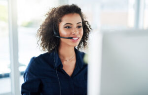 a young female call center agent working in her office.