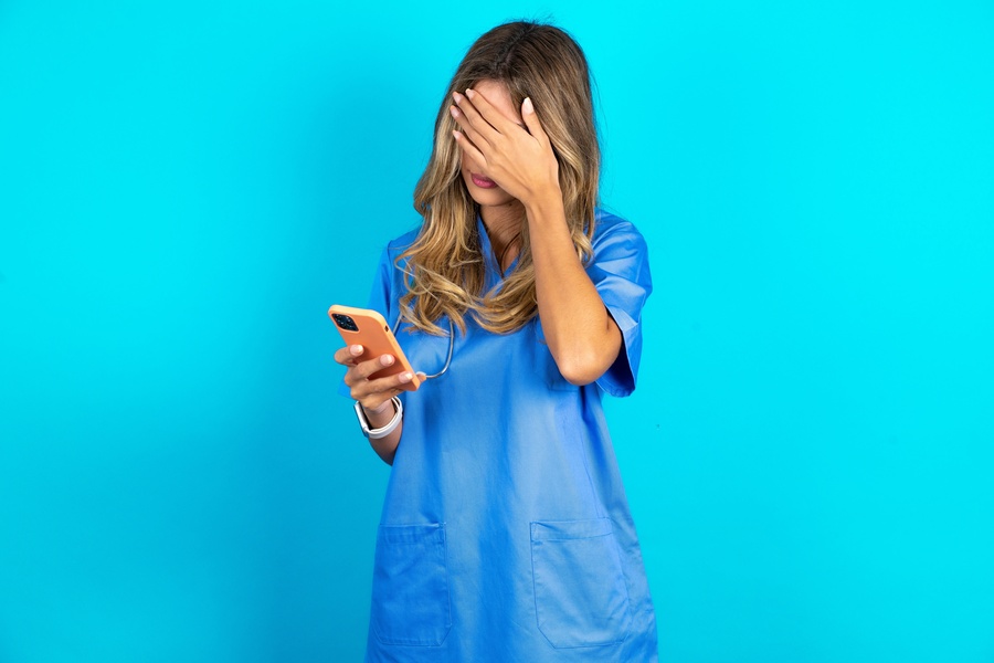 doctor checking phone for missed calls