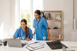 2 nurses working together on a laptop